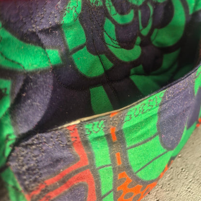 Close-up of the exterior patch pocket and quilted green, black and coral fabric on the Hibiscus & Sunflower bag.