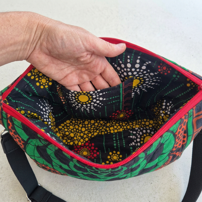 Hand slipping into an interior patch pocket of the Hibiscus & Sunflower bag